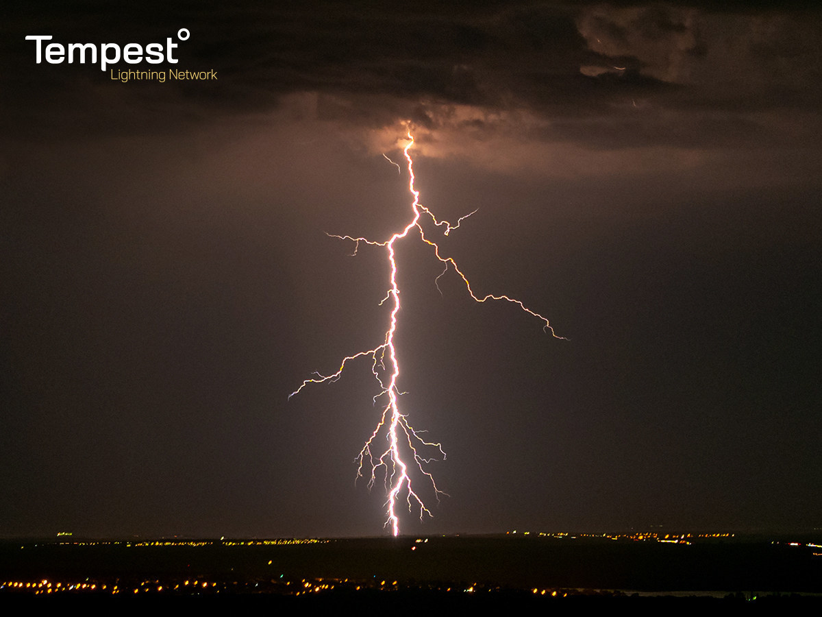 lightning striking over city at night