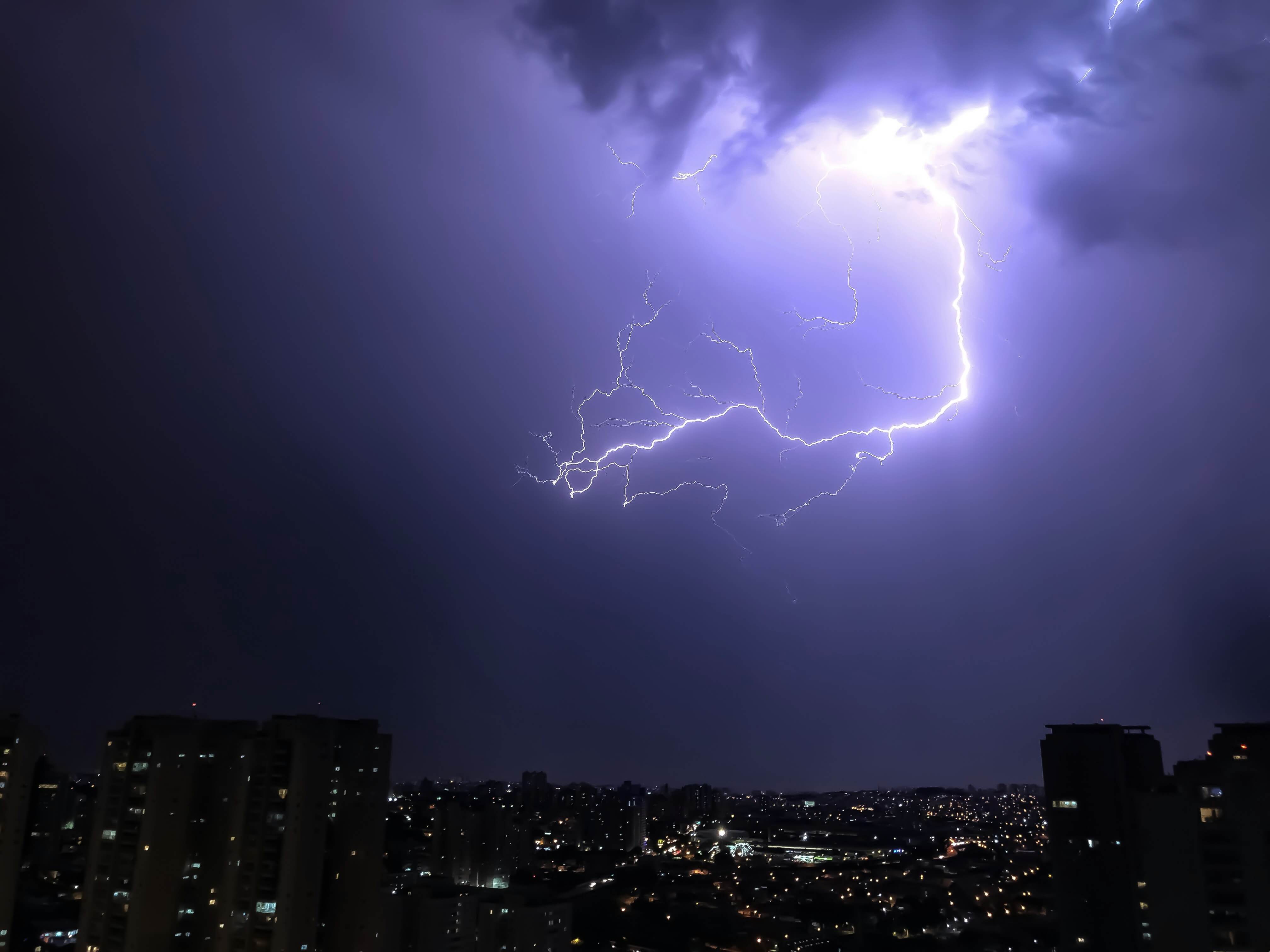 lightning hitting the air above a city