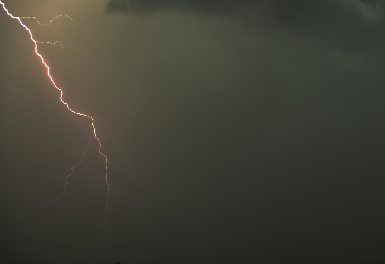 yellow heat lightning bolt in a gray sky