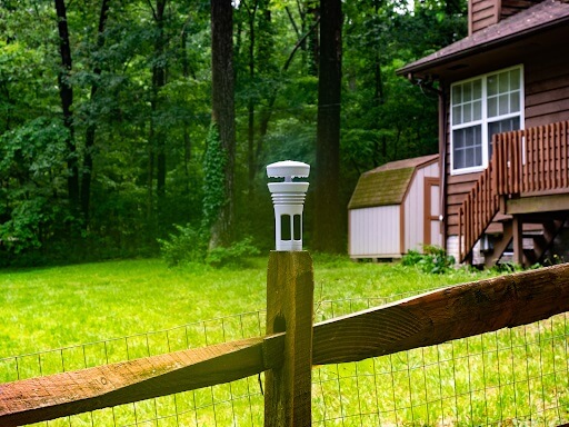 the Tempest Weather System mounted on a fence with the flat base mount