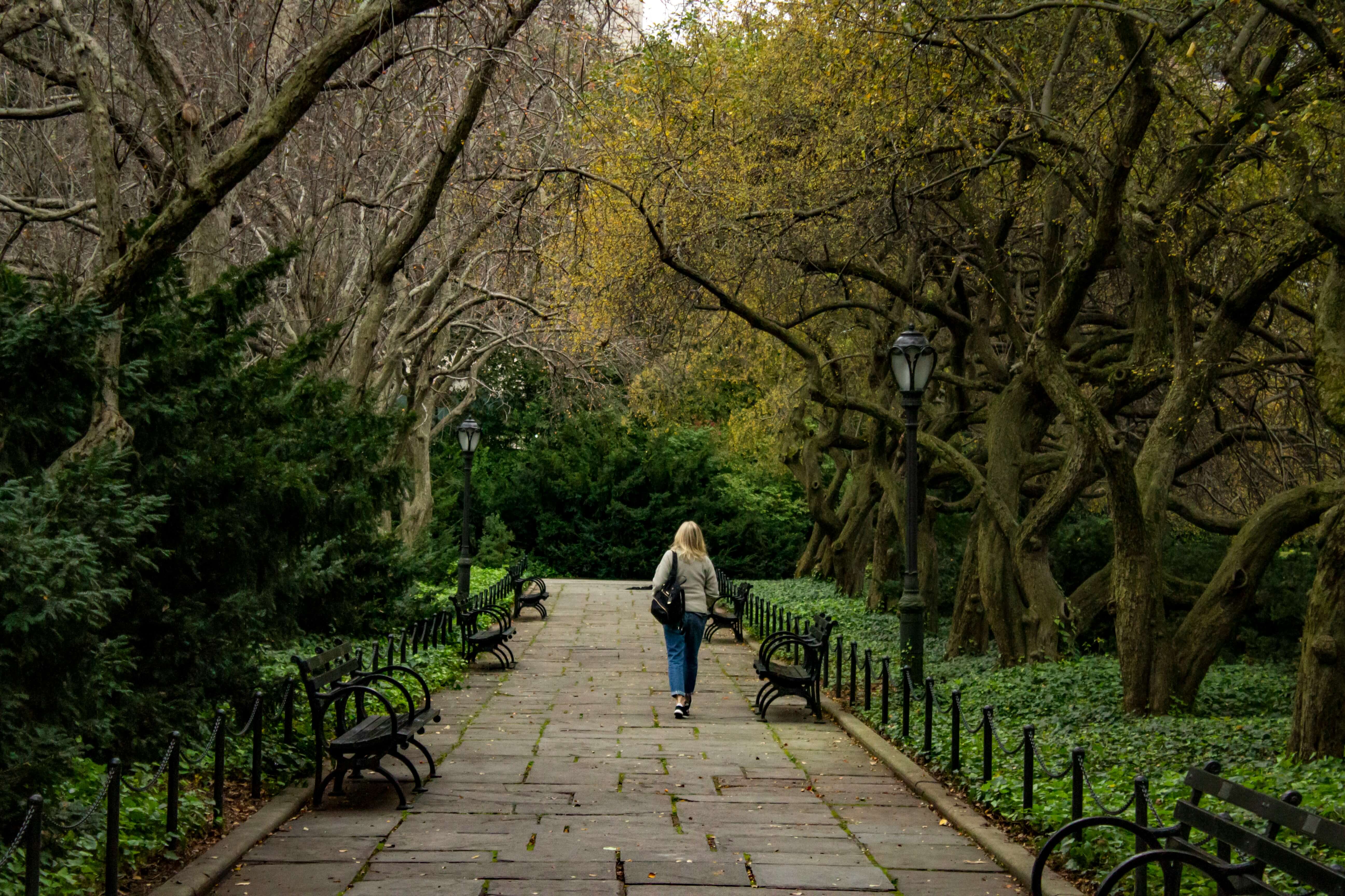 a person enjoying a walk in the woods to lift her mood