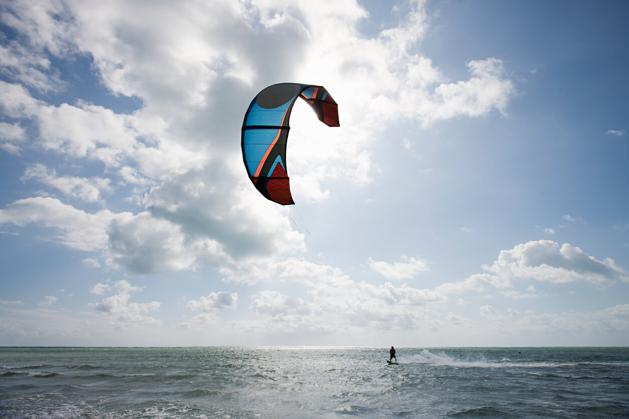 someone learning how to kitesurf on a partly cloudy day