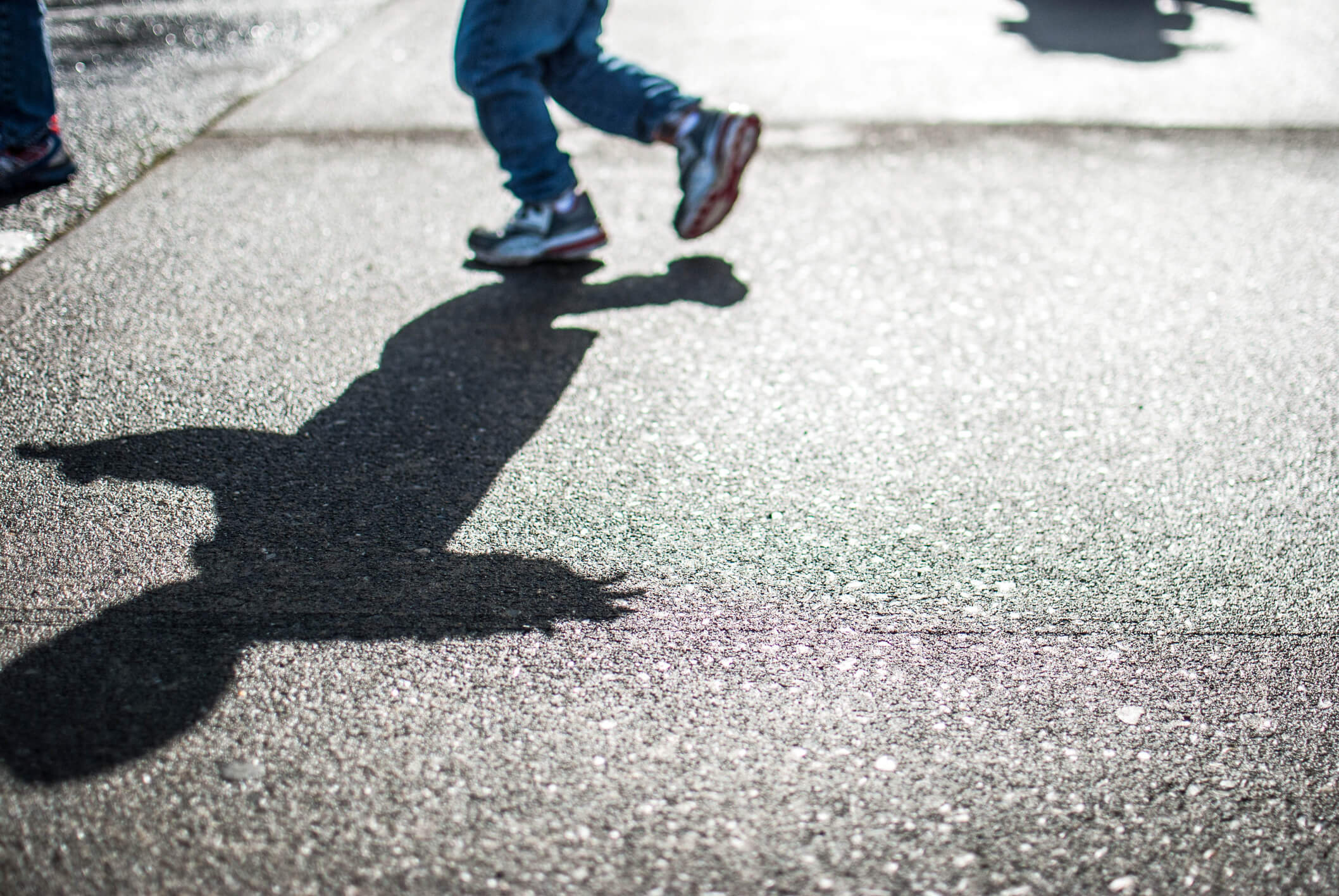 the shadow of a kid on the ground to show how the sun moves