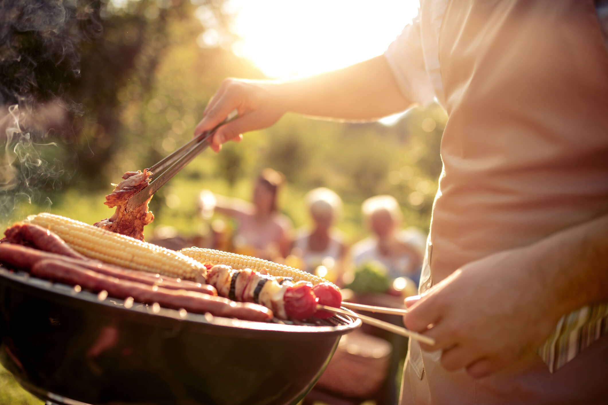 someone barbecuing at a backyard party