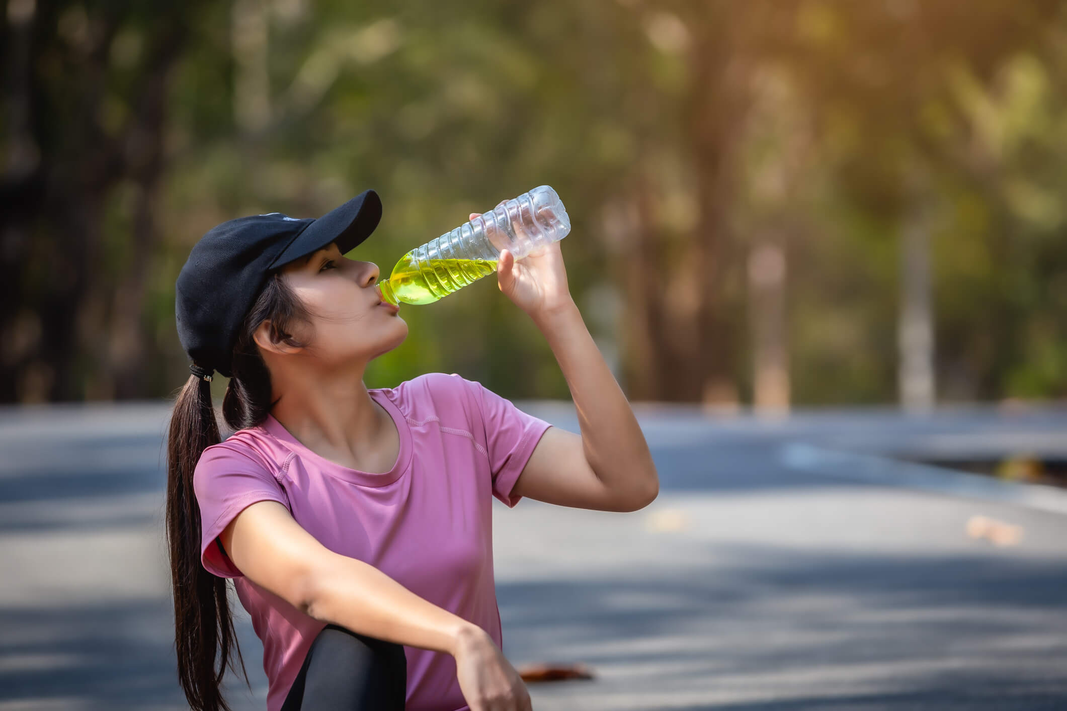 someone drinking electrolytes while outside to cool down